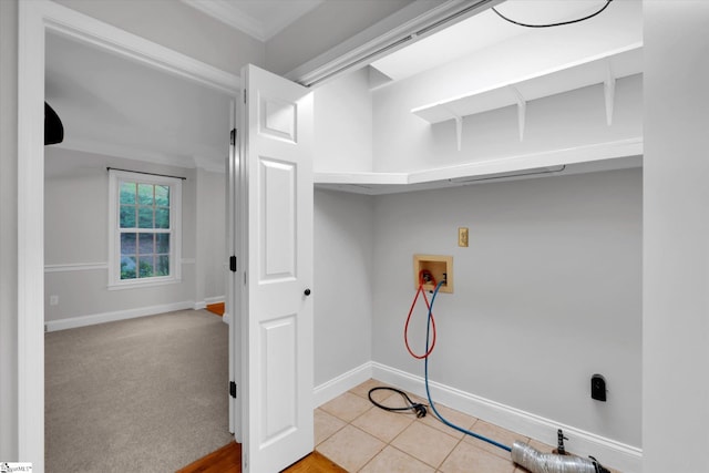 laundry room with washer hookup, baseboards, and crown molding