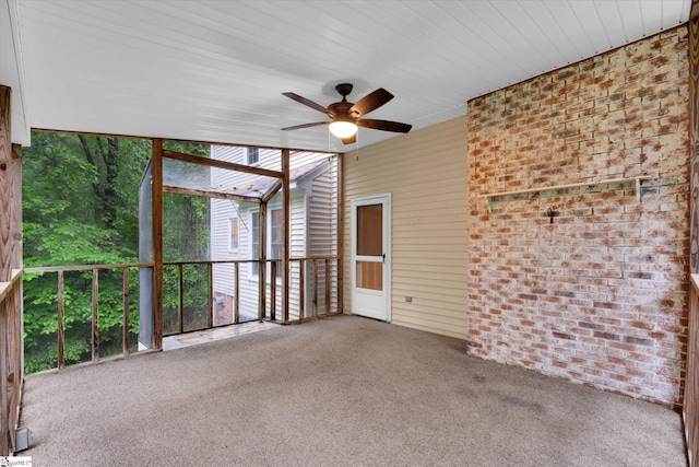 unfurnished sunroom with ceiling fan