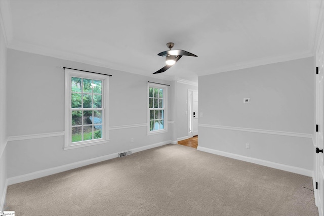 spare room featuring ornamental molding, carpet, ceiling fan, and baseboards