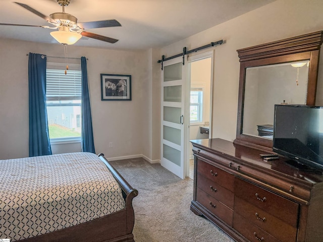 128 Adger Rd, Pendleton, SC 20670 - bedroom with light carpet, a barn door, baseboards, and a ceiling fan