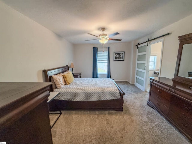 128 Adger Rd, Pendleton, SC 20670 - carpeted bedroom with a barn door, baseboards, and a ceiling fan