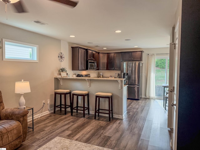 128 Adger Rd, Pendleton, SC 20670 - kitchen with appliances with stainless steel finishes, dark brown cabinets, a ceiling fan, a kitchen bar, and plenty of natural light