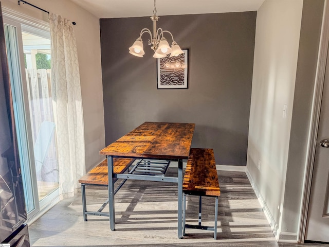 128 Adger Rd, Pendleton, SC 20670 - dining room with wood finished floors, a chandelier, and baseboards