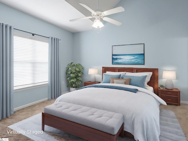 bedroom with light colored carpet, baseboards, multiple windows, ceiling fan, and lofted ceiling