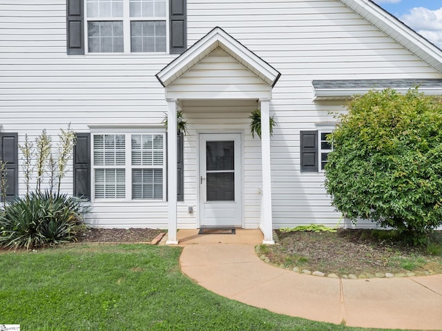 doorway to property with a yard