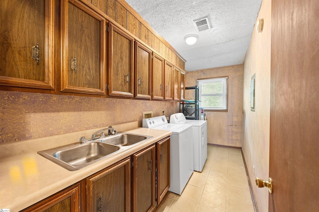 11 Crestview Ct, Piedmont, SC 29673 - laundry area featuring separate washer and dryer, cabinet space, a textured ceiling, light tile patterned flooring, and baseboards