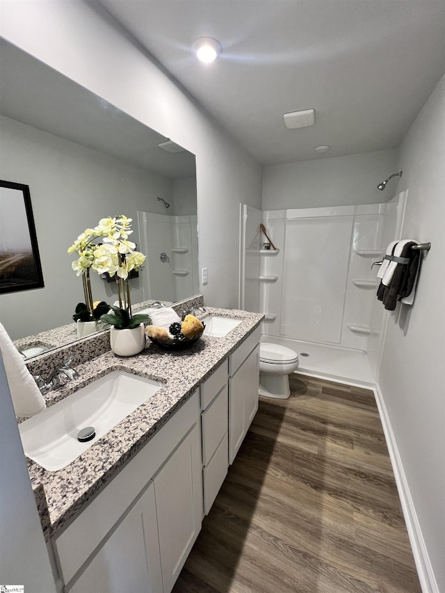 1222 Forestbrook Ln, Spartanburg, SC 29303 - bathroom with a shower, toilet, wood finished floors, and double vanity