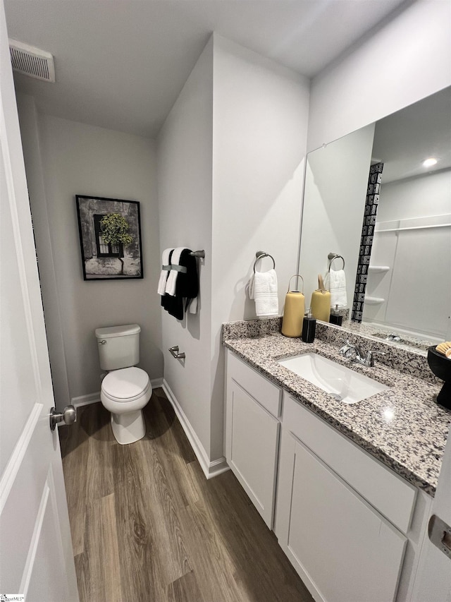 1222 Forestbrook Ln, Spartanburg, SC 29303 - bathroom featuring wood finished floors, toilet, vanity, and baseboards