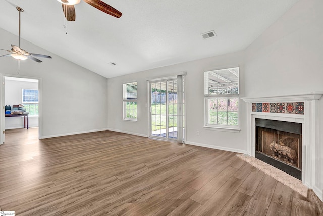1105 Autumn Leaf Ln, Fountain Inn, SC 29644 - unfurnished living room with ceiling fan, vaulted ceiling, wood finished floors, a tile fireplace, and baseboards