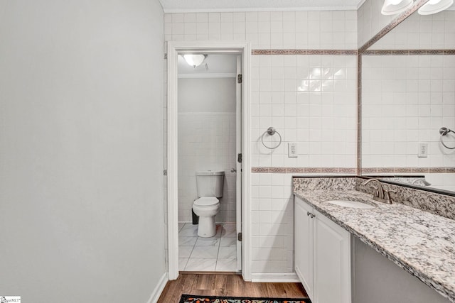 1105 Autumn Leaf Ln, Fountain Inn, SC 29644 - bathroom with tile walls, ornamental molding, wood finished floors, vanity, and toilet