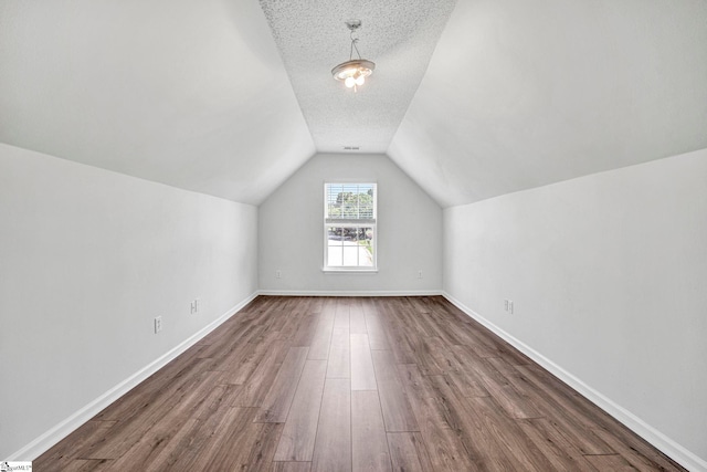 1105 Autumn Leaf Ln, Fountain Inn, SC 29644 - additional living space with vaulted ceiling, dark wood-type flooring, a textured ceiling, and baseboards