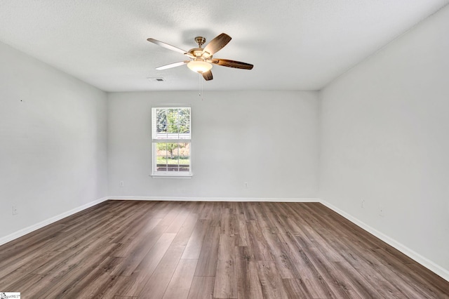 1105 Autumn Leaf Ln, Fountain Inn, SC 29644 - empty room with dark wood finished floors, ceiling fan, baseboards, and a textured ceiling