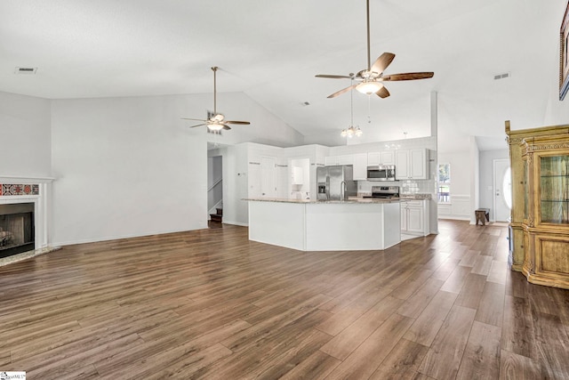 1105 Autumn Leaf Ln, Fountain Inn, SC 29644 - unfurnished living room with a ceiling fan, dark wood-style flooring, high vaulted ceiling, and a high end fireplace