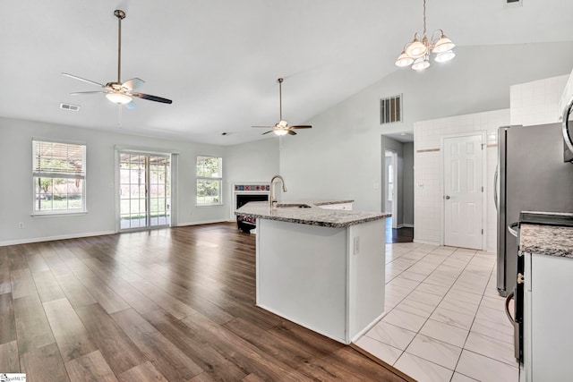 1105 Autumn Leaf Ln, Fountain Inn, SC 29644 - kitchen featuring ceiling fan, open floor plan, high vaulted ceiling, white cabinets, and a sink
