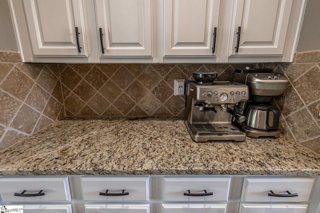 112 Murdock Ln, Greer, SC 29651 - kitchen with white cabinetry, decorative backsplash, and light stone countertops