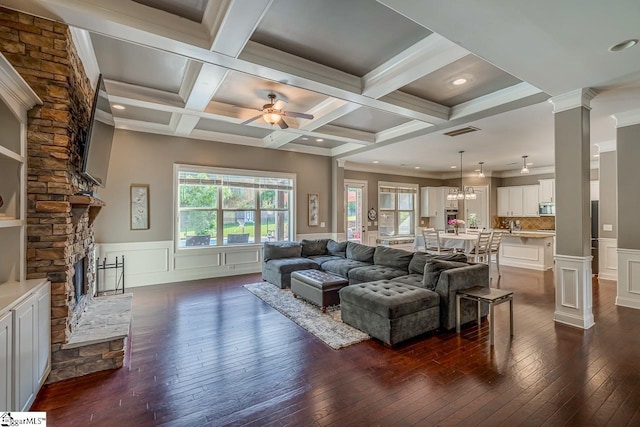 112 Murdock Ln, Greer, SC 29651 - living area with dark wood-style flooring, decorative columns, ceiling fan, a stone fireplace, and beam ceiling