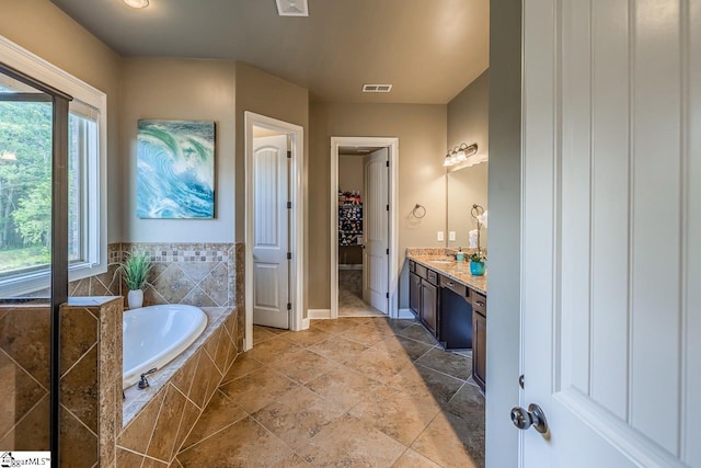 112 Murdock Ln, Greer, SC 29651 - bathroom with a garden tub, vanity, a spacious closet, and baseboards