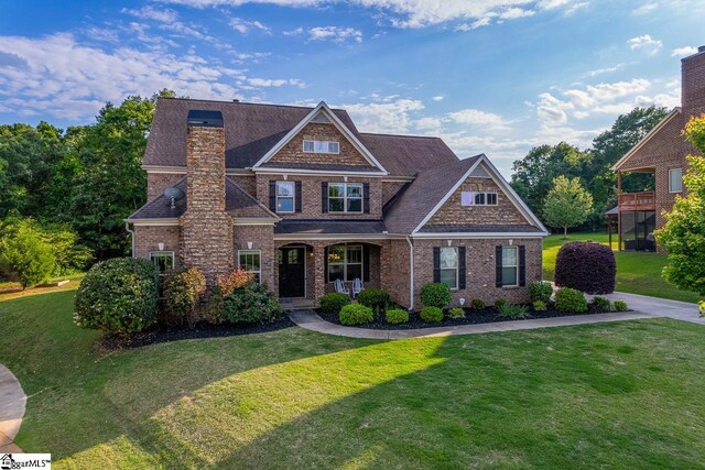 112 Murdock Ln, Greer, SC 29651 - view of front facade featuring a chimney, a front yard, brick siding, a porch, and a shingled roof