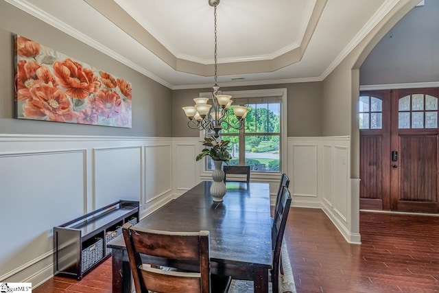 112 Murdock Ln, Greer, SC 29651 - dining room featuring a tray ceiling, a decorative wall, a chandelier, plenty of natural light, and dark wood-style floors