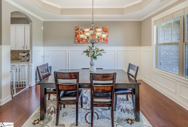 112 Murdock Ln, Greer, SC 29651 - dining space with a raised ceiling, dark wood-style flooring, a decorative wall, a chandelier, and arched walkways