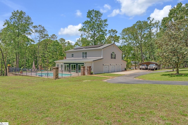 317 Hunter Rd, Fountain Inn, SC 29644 - rear view of house with solar panels, asphalt driveway, an attached garage, and french doors