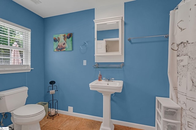 317 Hunter Rd, Fountain Inn, SC 29644 - full bathroom with toilet, baseboards, tile patterned floors, and curtained shower