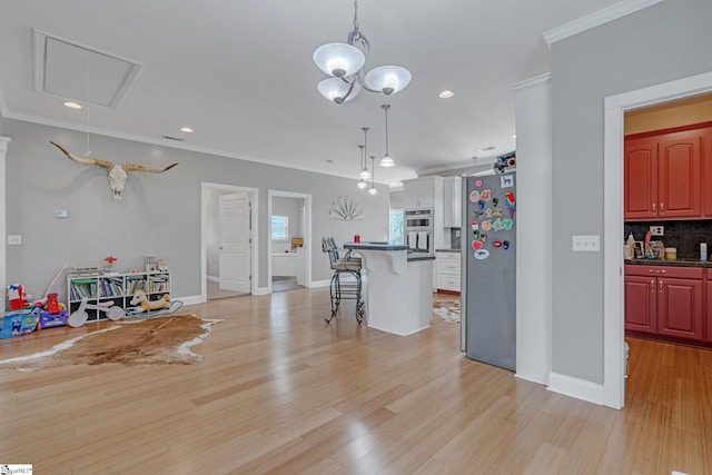 317 Hunter Rd, Fountain Inn, SC 29644 - kitchen with appliances with stainless steel finishes, a breakfast bar area, crown molding, light wood-type flooring, and dark countertops