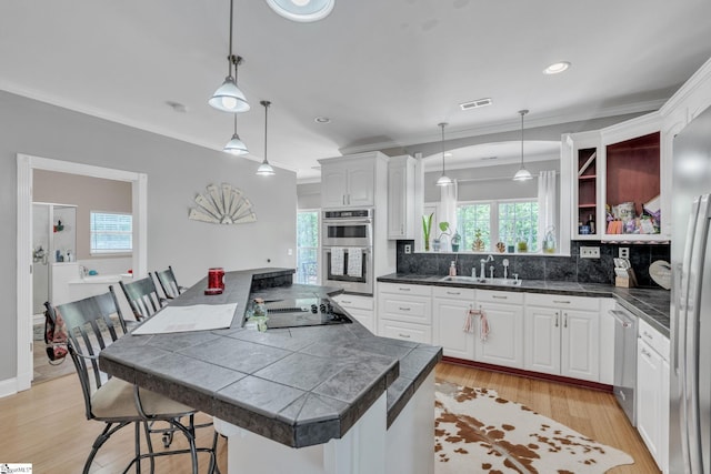 317 Hunter Rd, Fountain Inn, SC 29644 - kitchen with a sink, appliances with stainless steel finishes, white cabinets, open shelves, and decorative backsplash