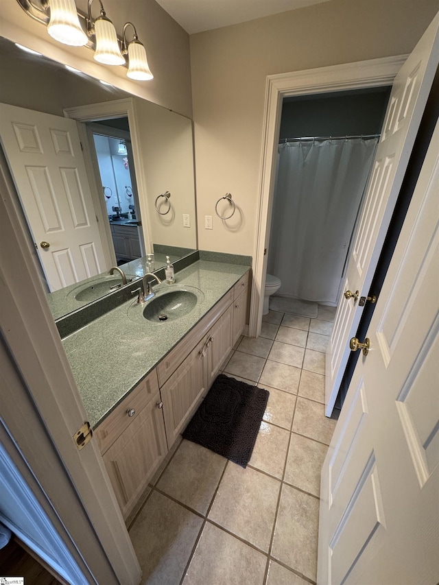 full bathroom with tile patterned flooring, vanity, and toilet