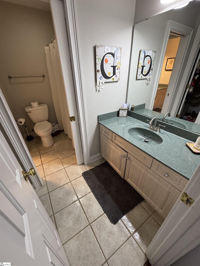 bathroom featuring tile patterned floors, vanity, and toilet