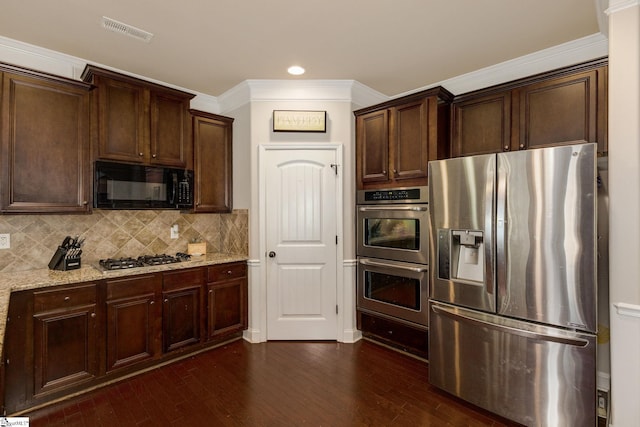 9 Bellagio Way, Greer, SC 29650 - kitchen featuring stainless steel appliances, light stone countertops, dark brown cabinets, dark wood-type flooring, and ornamental molding