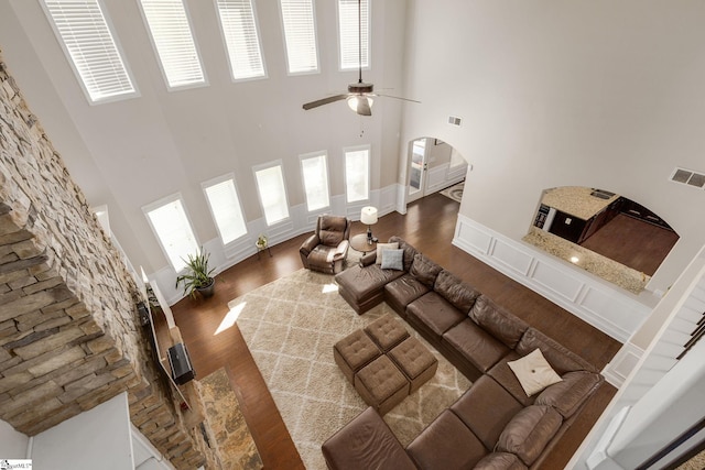 9 Bellagio Way, Greer, SC 29650 - living room with a towering ceiling, arched walkways, wood finished floors, and ceiling fan