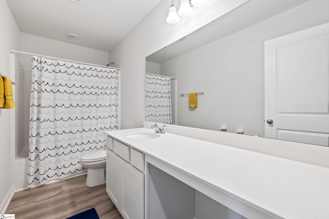 full bathroom with toilet, wood finished floors, vanity, and shower / bath combination with curtain