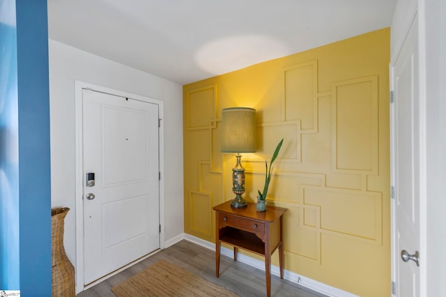 foyer with wood finished floors and baseboards