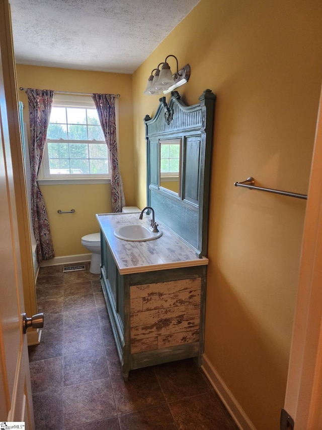 199 Ccc Camp Rd, Greer, SC 29651 - full bathroom with toilet, vanity, a textured ceiling, and baseboards
