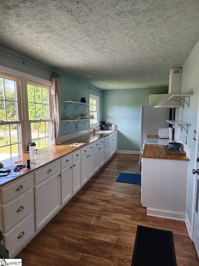 199 Ccc Camp Rd, Greer, SC 29651 - kitchen featuring open shelves, a sink, white cabinets, dark wood-style flooring, and a textured ceiling