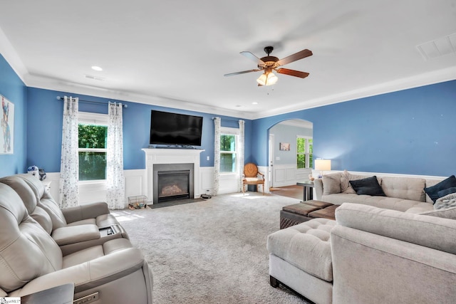 549 Allenton Way, Greer, SC 29651 - living area featuring wainscoting, arched walkways, carpet flooring, a fireplace with flush hearth, and a ceiling fan