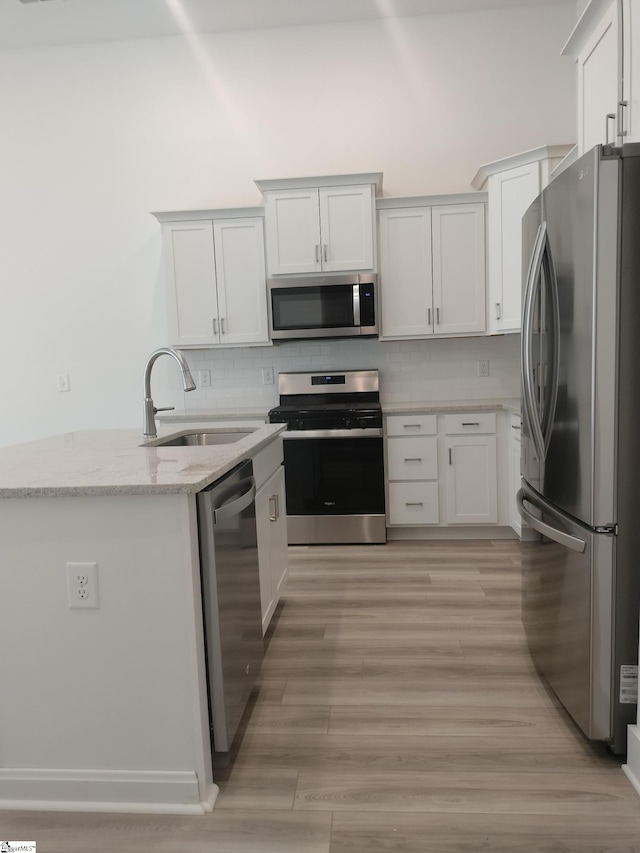 234 Woodhouse Way # 1, Greenville, SC 29605 - kitchen featuring appliances with stainless steel finishes, a sink, light stone counters, and decorative backsplash
