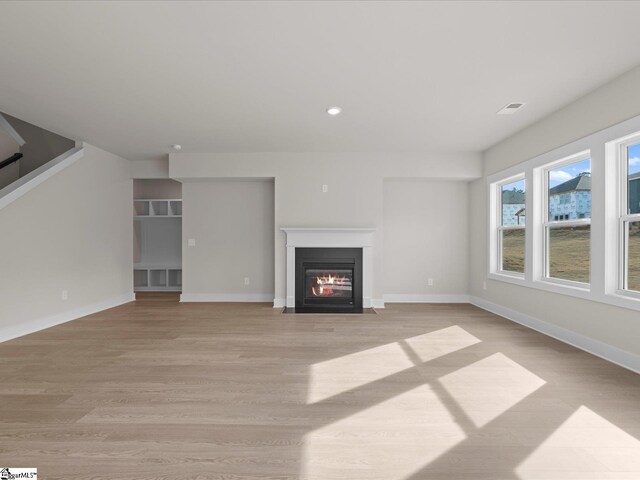 304 Lorca Dr, Greenville, SC 29605 - unfurnished living room with a fireplace with flush hearth, light wood-type flooring, recessed lighting, and baseboards
