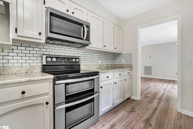 167 Lake Bowen Dr, Inman, SC 29349 - kitchen with appliances with stainless steel finishes, white cabinets, and light wood-style flooring