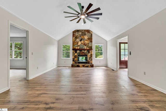 167 Lake Bowen Dr, Inman, SC 29349 - unfurnished living room with a ceiling fan, lofted ceiling, wood finished floors, a stone fireplace, and baseboards