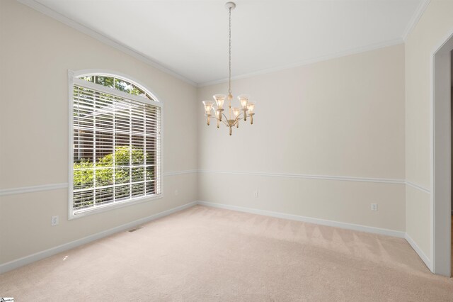 empty room featuring carpet, ornamental molding, baseboards, and a chandelier