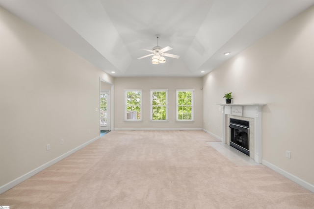 unfurnished living room with a fireplace with flush hearth, light colored carpet, a ceiling fan, baseboards, and recessed lighting