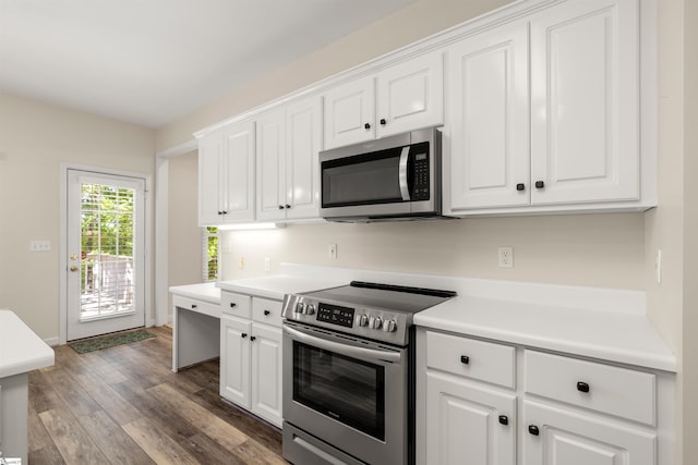 kitchen featuring stainless steel appliances, wood finished floors, white cabinets, and light countertops