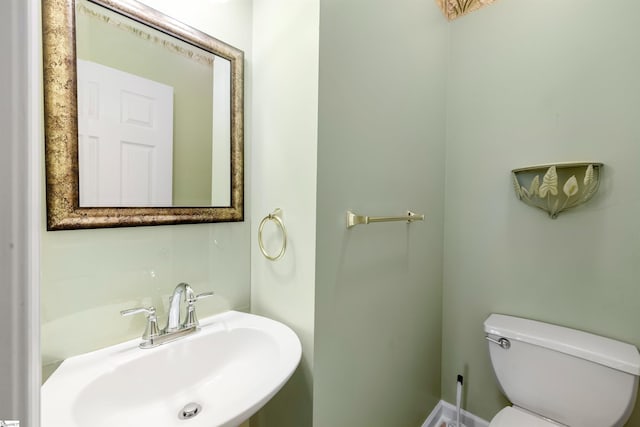 half bathroom with a sink and toilet
