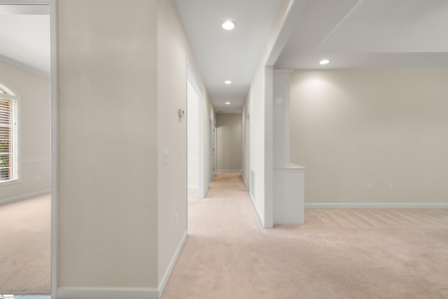 hallway featuring light carpet, recessed lighting, and baseboards