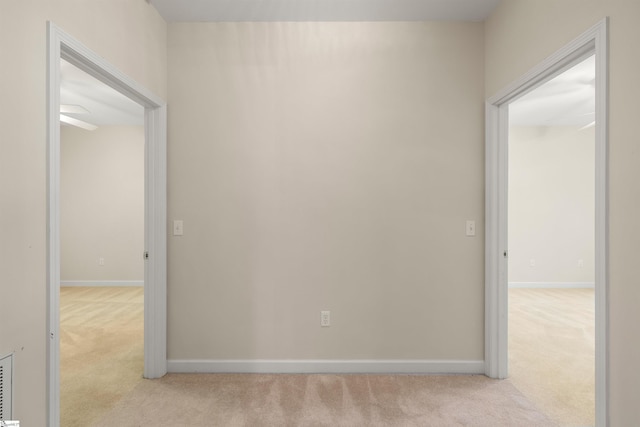 unfurnished room with carpet flooring and baseboards