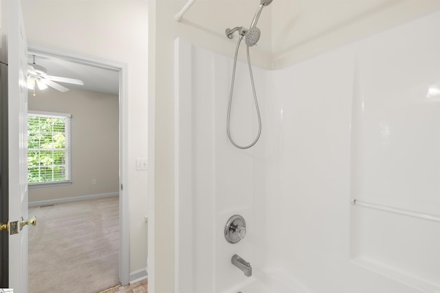 bathroom with bathtub / shower combination, baseboards, and a ceiling fan