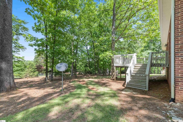 view of yard featuring stairs and a deck