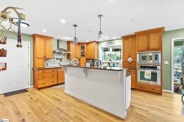 700 Old Green Pond Rd, Anderson, SC 29625 - kitchen featuring stainless steel appliances, wall chimney exhaust hood, light wood-style flooring, decorative backsplash, and recessed lighting